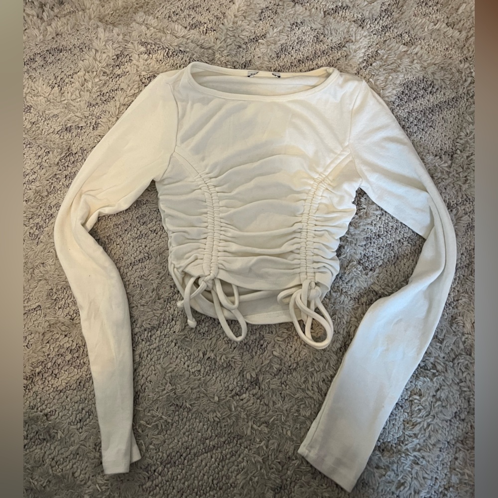 white long sleeve top with ruching on sides